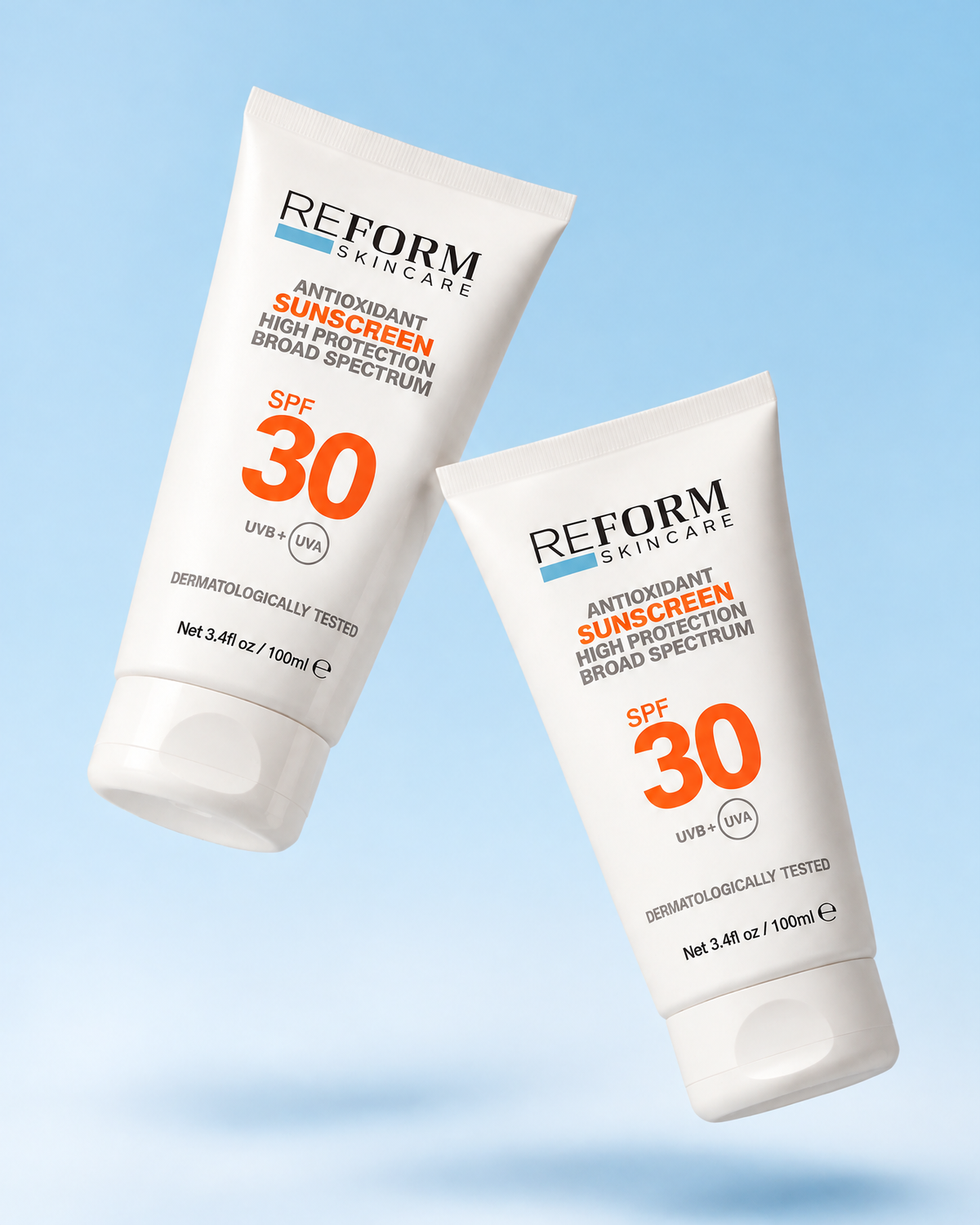 Two tubes of REFORM Skincare SPF30 Antioxidant Sunscreen on a blue background